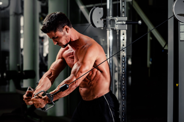 man using cable machine at gym